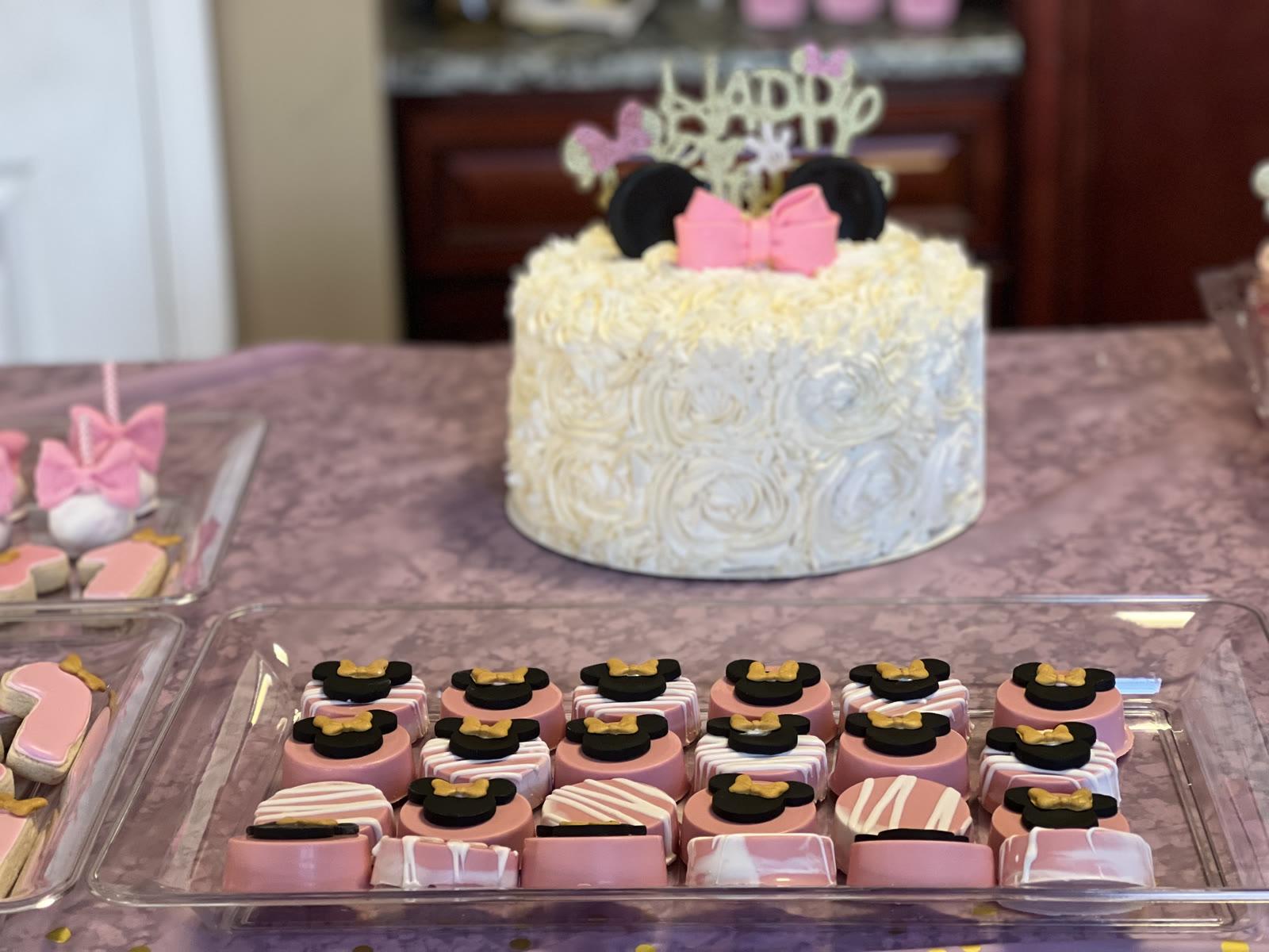 White buttercream rosette celebration cake with a glittery Happy Birthday topper and Minnie Mouse ears